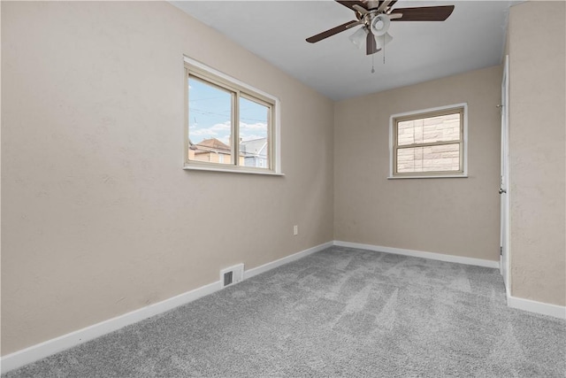 138 W Larkspur St, Munhall, PA 15120 - spare room featuring a ceiling fan, visible vents, a wealth of natural light, and carpet flooring