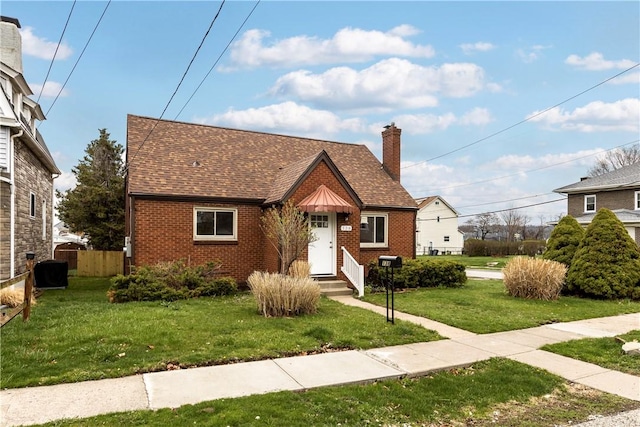 138 W Larkspur St, Munhall, PA 15120 - view of front of home with a chimney, a front lawn, brick siding, and entry steps