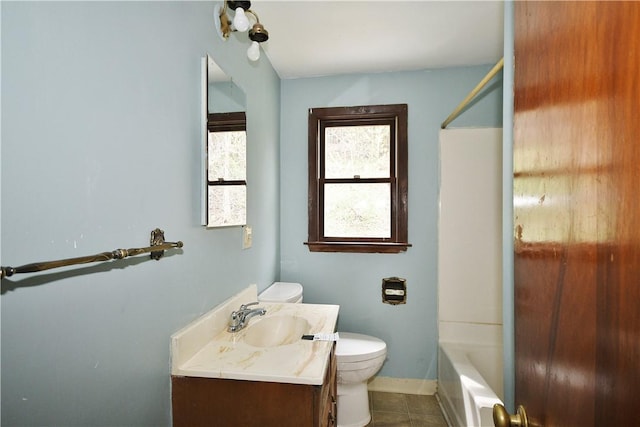 full bath featuring tile patterned flooring, toilet, vanity, baseboards, and  shower combination