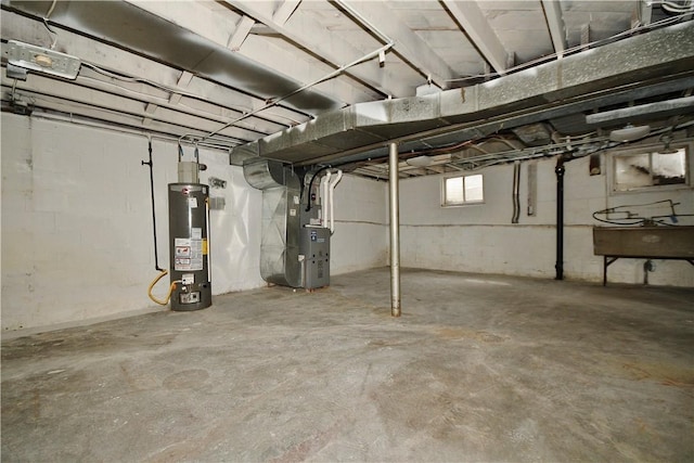 basement featuring water heater and heating unit