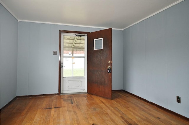 entrance foyer featuring ornamental molding and wood-type flooring