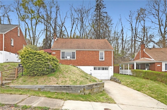 view of front of property featuring a chimney, fence, concrete driveway, brick siding, and a garage