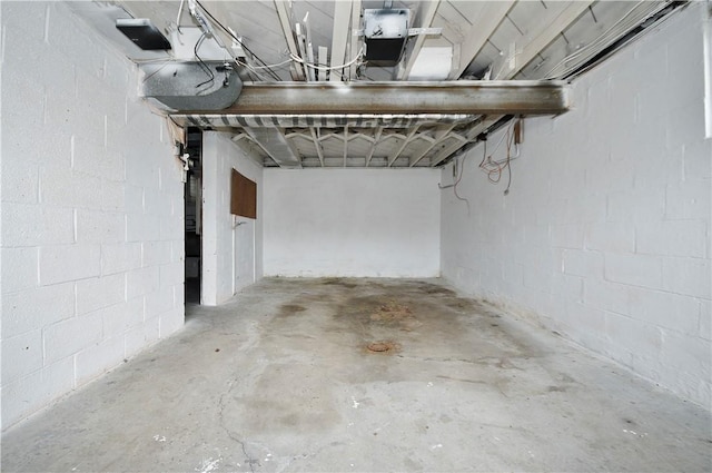 unfinished below grade area featuring concrete block wall