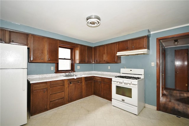 kitchen featuring a sink, white appliances, light floors, light countertops, and under cabinet range hood