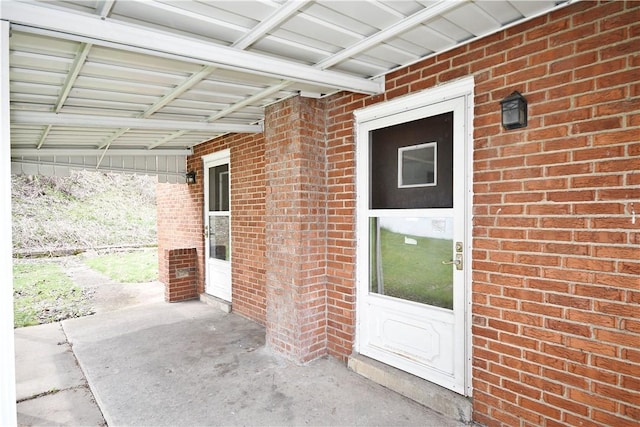 view of exterior entry with brick siding