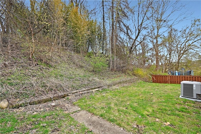 view of yard featuring cooling unit and fence