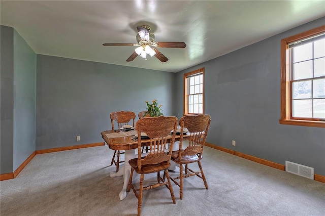 dining room featuring baseboards, light colored carpet, and visible vents