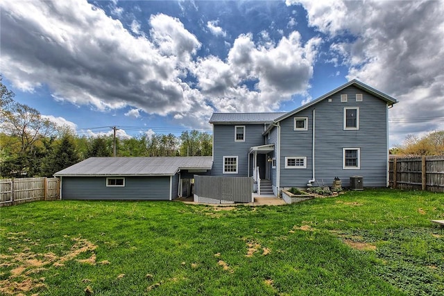 back of property featuring a fenced backyard, a yard, and cooling unit