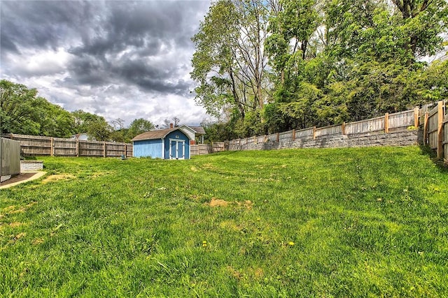 view of yard featuring an outdoor structure, a fenced backyard, and a shed