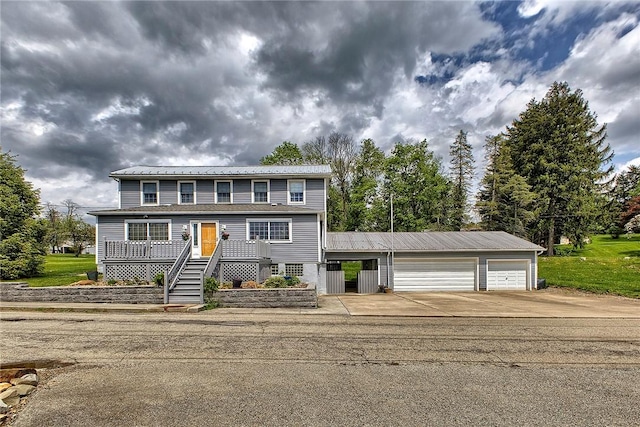 view of front of property featuring metal roof, stairs, and a garage