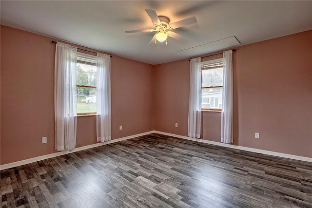 empty room featuring baseboards, plenty of natural light, a ceiling fan, and wood finished floors