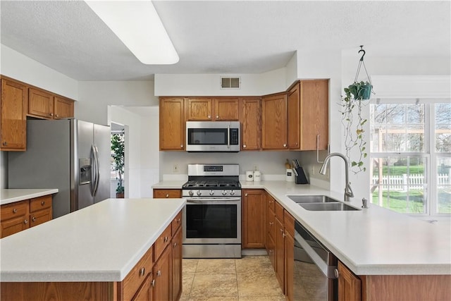827 Brookfield Dr, Seven Fields Boro, PA 16046 - kitchen with appliances with stainless steel finishes, a sink, and brown cabinetry