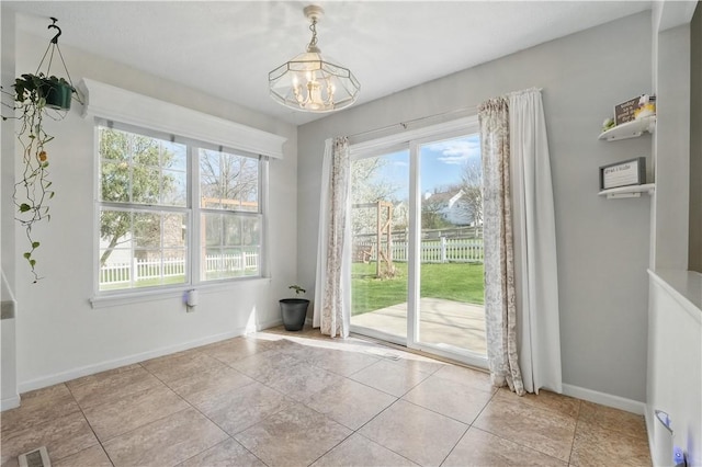 827 Brookfield Dr, Seven Fields Boro, PA 16046 - unfurnished dining area with a chandelier, baseboards, and light tile patterned floors