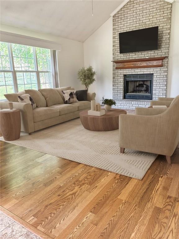 827 Brookfield Dr, Seven Fields Boro, PA 16046 - living room with lofted ceiling, wood finished floors, and a fireplace