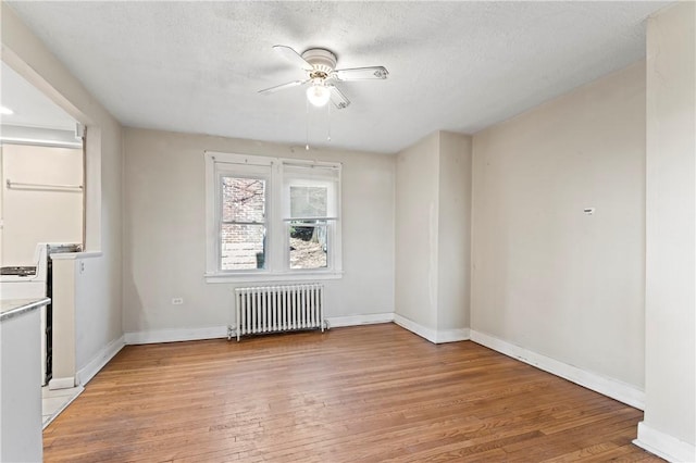 2006 Locust St, Swissvale, PA 15218 - empty room with radiator, a ceiling fan, light wood finished floors, and baseboards