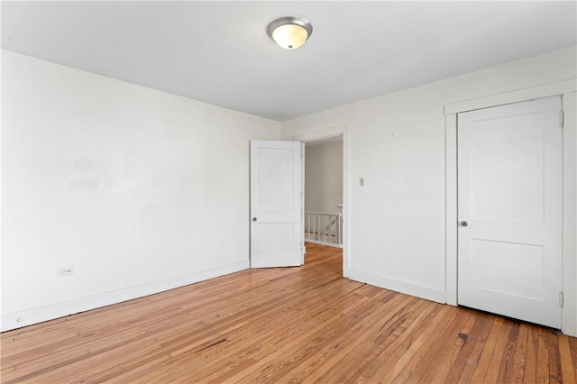 2006 Locust St, Swissvale, PA 15218 - unfurnished bedroom with light wood-style floors, baseboards, and a closet
