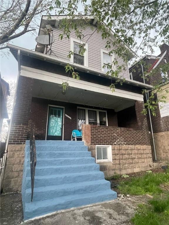 2006 Locust St, Swissvale, PA 15218 - view of front of property with stairs, a porch, and brick siding