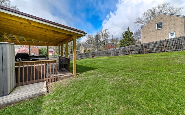 view of yard featuring a fenced backyard and a deck