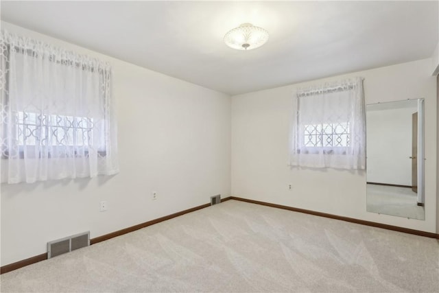 unfurnished bedroom with baseboards, visible vents, and carpet