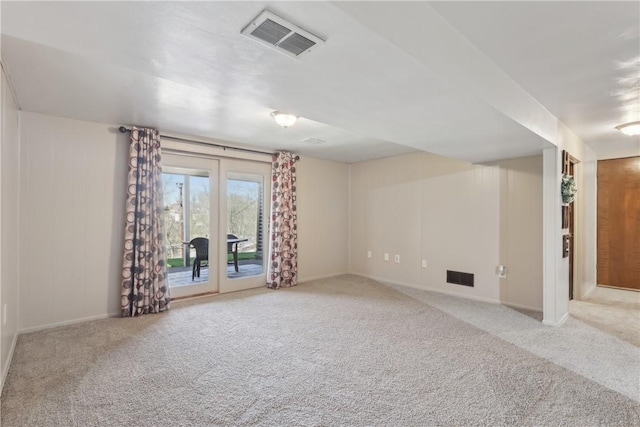 carpeted spare room with baseboards and visible vents