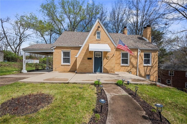 211 Wainwright Ave, Brentwood, PA 15227 - view of front of house with a carport, a chimney, brick siding, a shingled roof, and a front yard