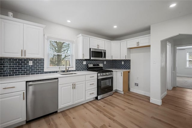 211 Wainwright Ave, Brentwood, PA 15227 - kitchen with a sink, stainless steel appliances, light wood finished floors, light countertops, and white cabinets