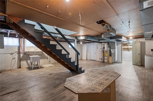 211 Wainwright Ave, Brentwood, PA 15227 - below grade area with stairway, water heater, heating unit, and wood finished floors