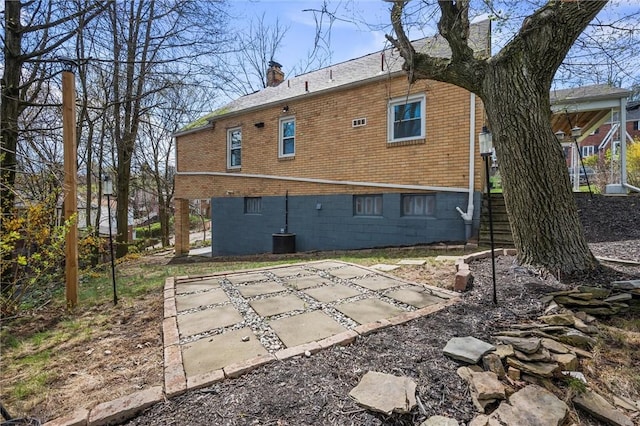 211 Wainwright Ave, Brentwood, PA 15227 - back of house with central AC, a chimney, brick siding, a patio area, and stairs