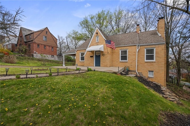 211 Wainwright Ave, Brentwood, PA 15227 - view of front of property featuring a chimney, a shingled roof, an attached carport, a front yard, and brick siding