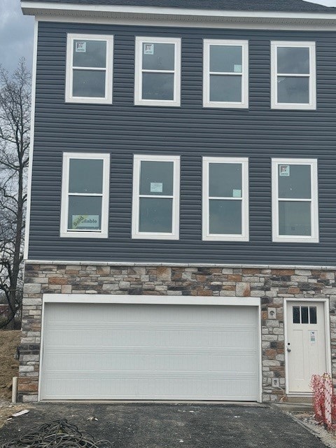 676 Olivia St, Collier Twp, PA 15205 - view of front of home featuring a garage and stone siding