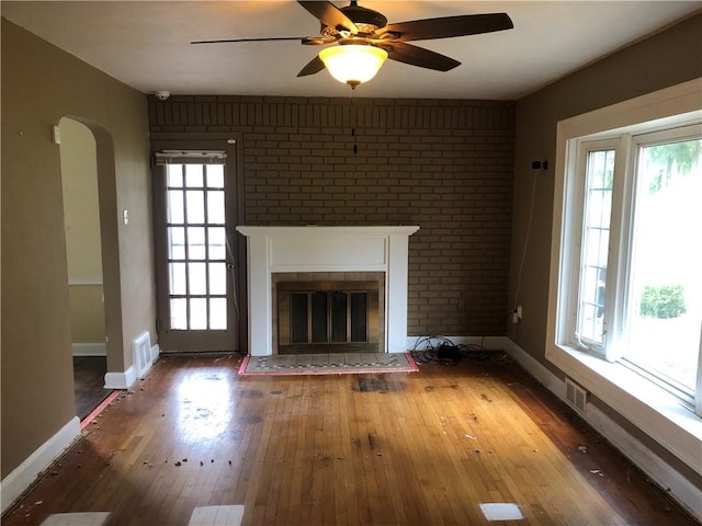 159 Oakville Rd, Chippewa Twp, PA 15010 - unfurnished living room featuring hardwood / wood-style flooring, arched walkways, and healthy amount of natural light