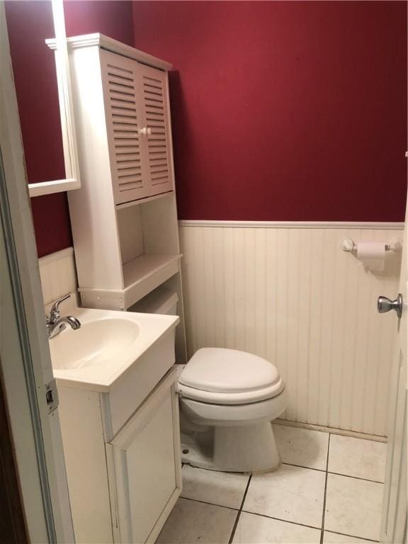 159 Oakville Rd, Chippewa Twp, PA 15010 - half bathroom with a wainscoted wall, toilet, vanity, and tile patterned flooring
