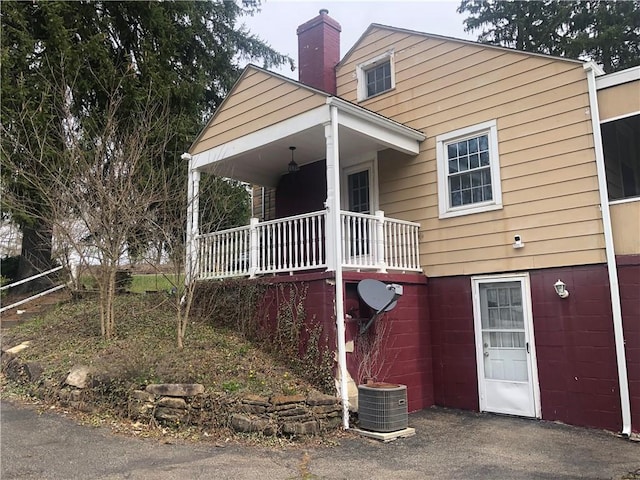 159 Oakville Rd, Chippewa Twp, PA 15010 - view of front facade featuring a porch, a chimney, and central air condition unit