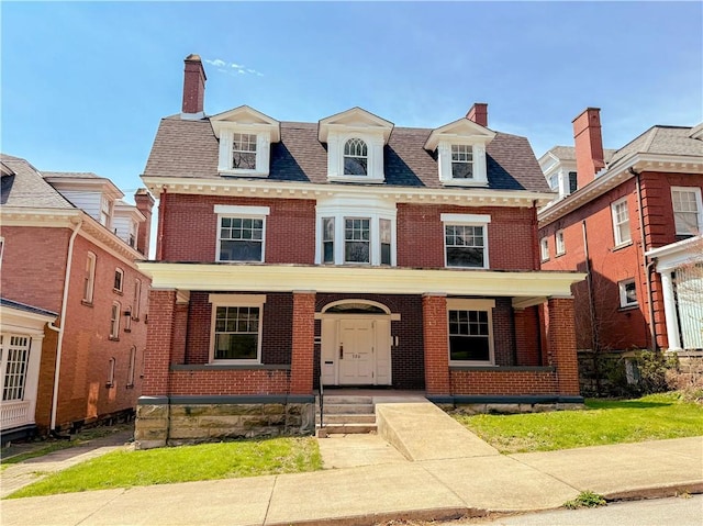 view of front of home featuring brick siding, a porch, and a chimney