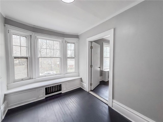interior space featuring baseboards, visible vents, ornamental molding, and dark wood-style flooring