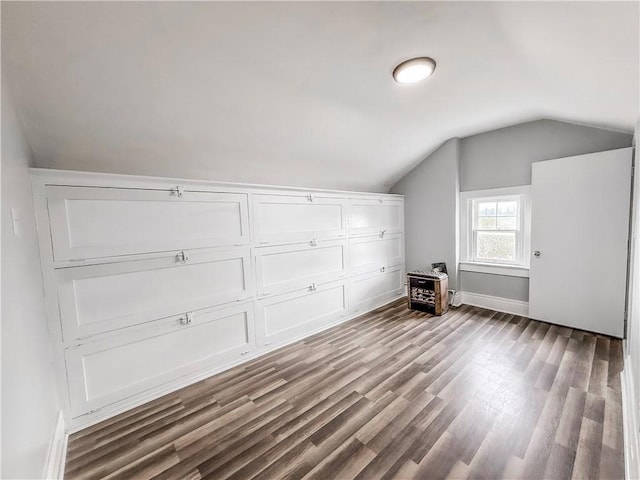 bonus room featuring lofted ceiling, baseboards, and wood finished floors