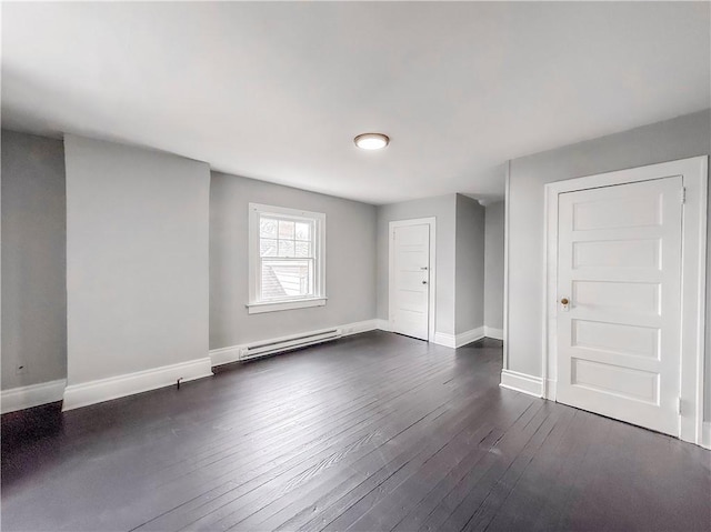 interior space featuring baseboards, a baseboard radiator, and dark wood finished floors
