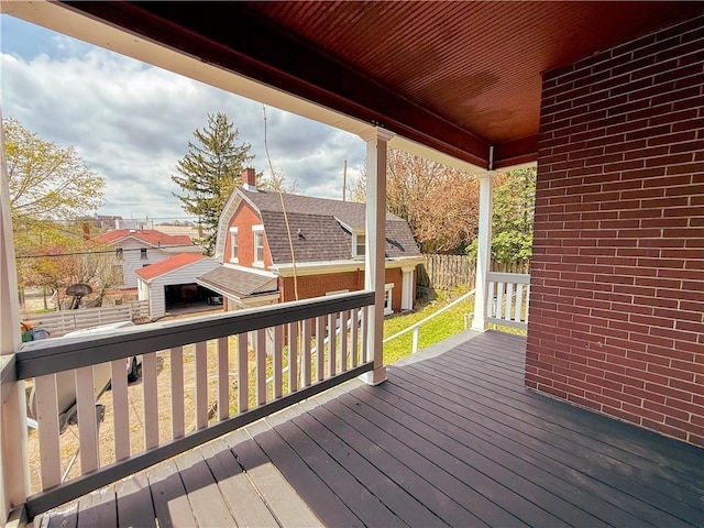 wooden terrace featuring fence and a residential view