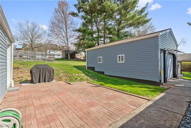 view of patio / terrace featuring an outdoor structure, fence, and area for grilling