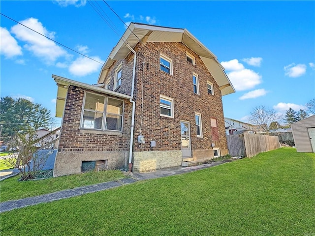 100 Shenango Blvd, Farrell, PA 16121 - view of side of property featuring fence, brick siding, and a yard