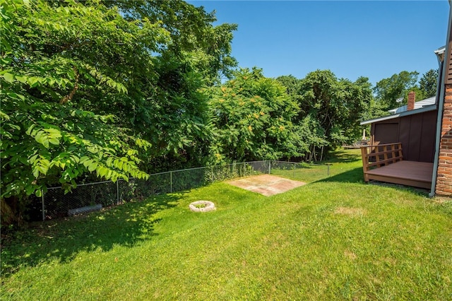 view of yard with fence and a deck