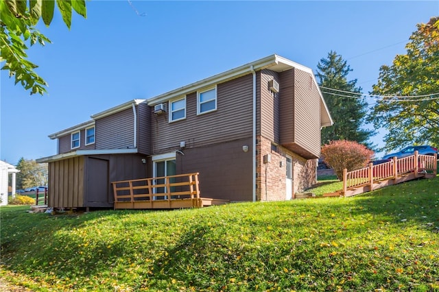rear view of property with a lawn and a deck