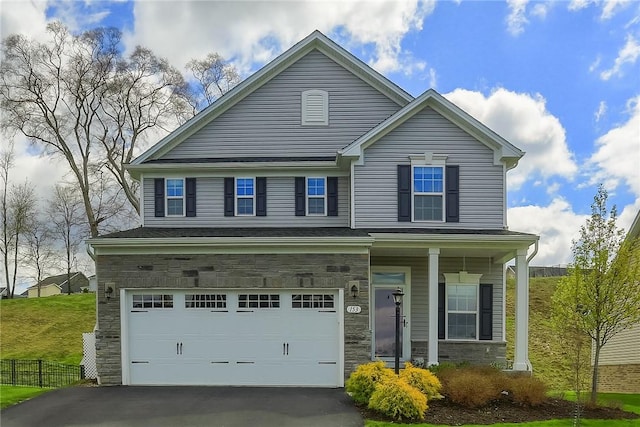 153 Piatt Estates Dr, Chartiers, PA 15301 - view of front of home with fence, covered porch, stone siding, an attached garage, and driveway