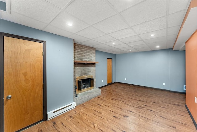 2925 Mcneal Rd, Hampton, PA 15101 - unfurnished living room with recessed lighting, wood finished floors, baseboards, a baseboard radiator, and a brick fireplace