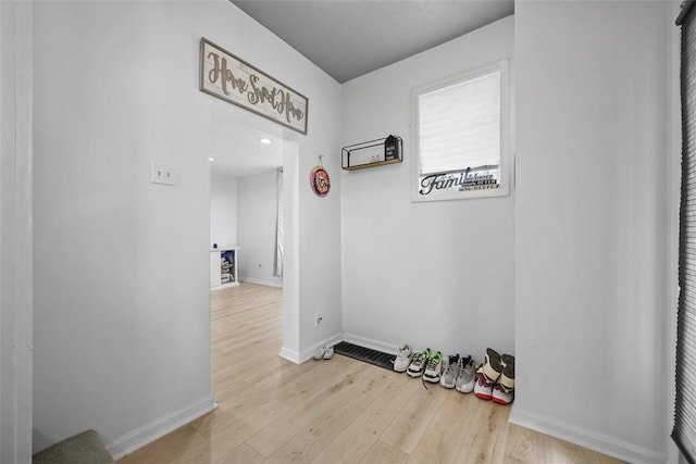 hall with wood finished floors and baseboards
