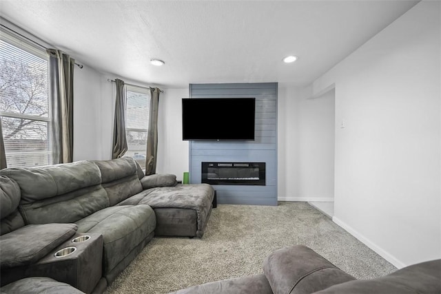 living room featuring recessed lighting, a fireplace, carpet flooring, and baseboards