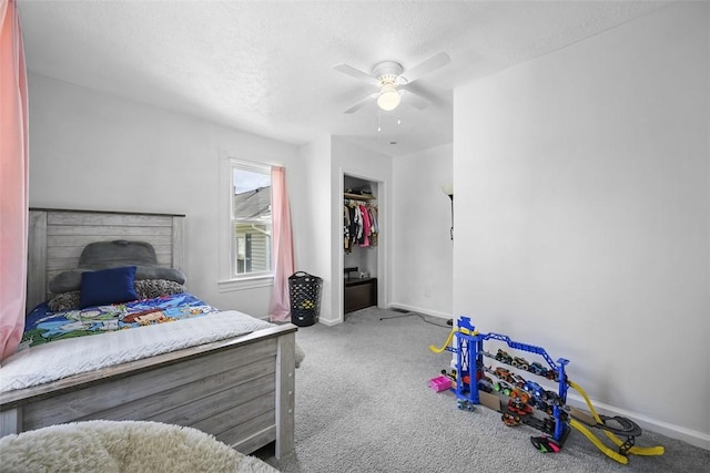 bedroom with carpet floors, a textured ceiling, a ceiling fan, and baseboards
