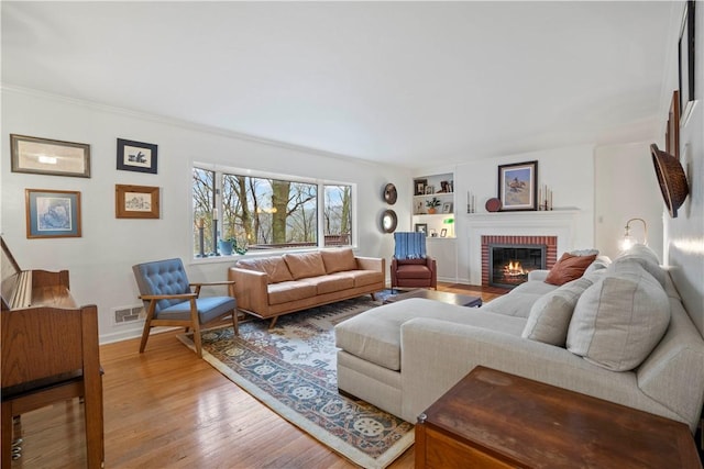 18 Oakglen Dr, Oakmont, PA 15139 - living area featuring wood finished floors, built in features, a fireplace, baseboards, and visible vents