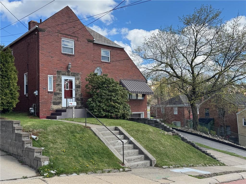 2157 Walton, Overbrook, PA 15210 - view of front of property with fence, a chimney, brick siding, and a front yard