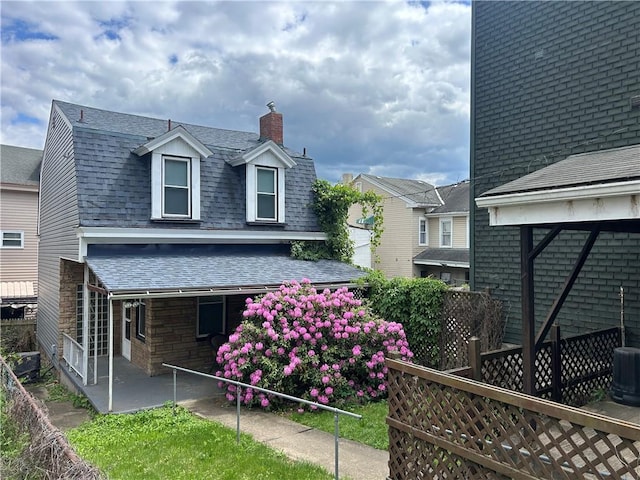 117 Sherman St, Rear, Millvale, PA 15209 - view of side of property with a shingled roof, a chimney, and central AC unit